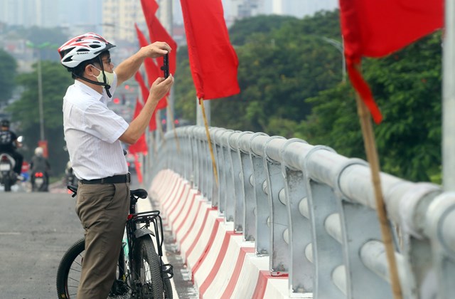 Trong ng&agrave;y đầu kh&aacute;nh th&agrave;nh, một số người d&acirc;n đi xe đạp l&ecirc;n cầu để chụp h&igrave;nh.