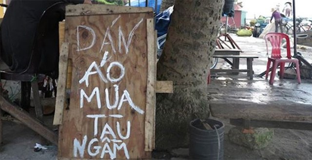 Tấm biển &ldquo;D&aacute;n &aacute;o mưa t&agrave;u ngầm&rdquo; ở phố cổ Hội An của ch&uacute; Sỹ.&nbsp;&nbsp;