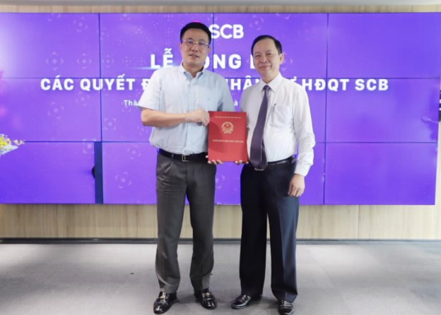 Ph&oacute; Thống đốc Thường trực Ng&acirc;n h&agrave;ng Nh&agrave; nước Đ&agrave;o Minh T&uacute; trao quyết định th&ocirc;i chỉ định chức Chủ tịch Hội đồng quản trị SCB cho &ocirc;ng Vũ Anh Đức